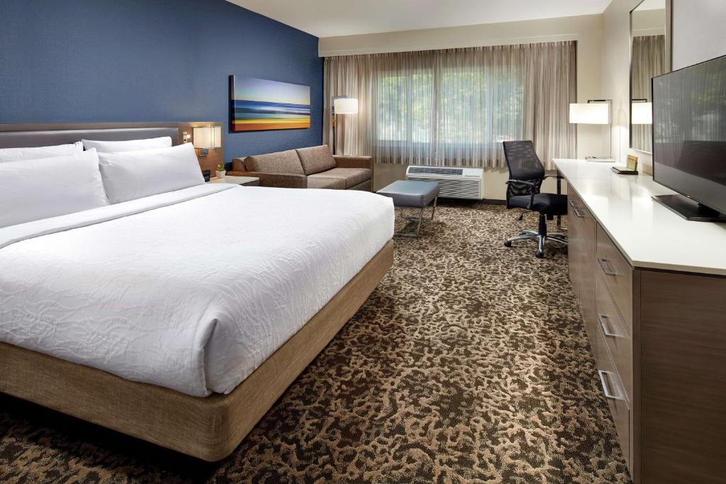 a hotel room with a large bed and a desk at Hilton Garden Inn San Diego Mission Valley/Stadium in San Diego