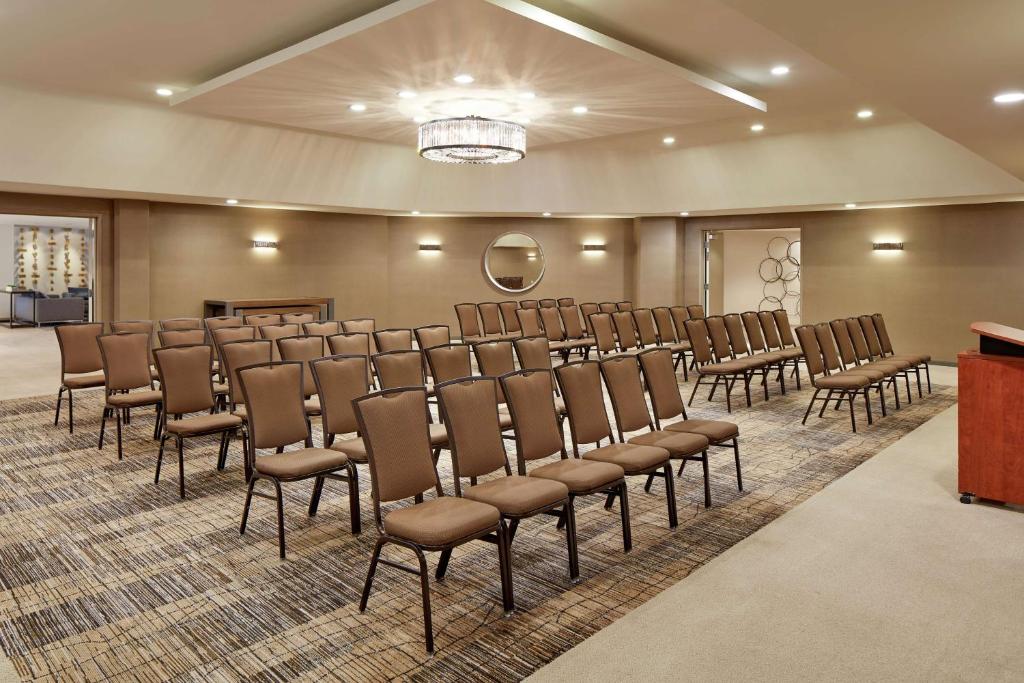 a large room with a row of chairs and a podium at Hilton Garden Inn San Diego Mission Valley/Stadium in San Diego