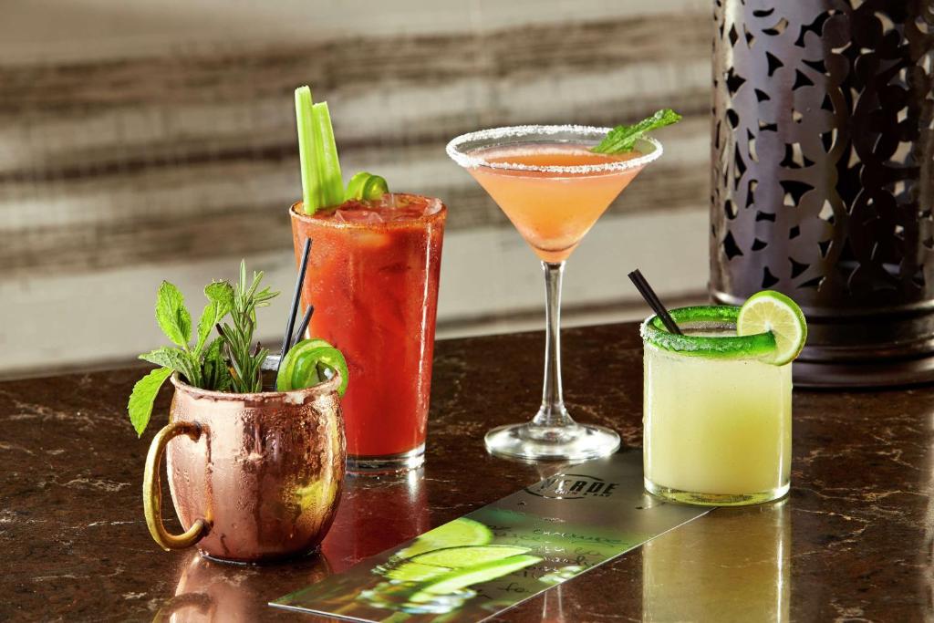 a group of three cocktails sitting on a table at Hilton Garden Inn San Diego Mission Valley/Stadium in San Diego