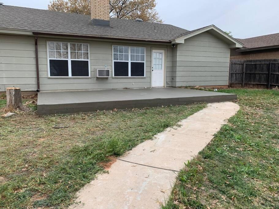 a house with a concrete driveway in front of it at Terry Kuhlman in San Angelo