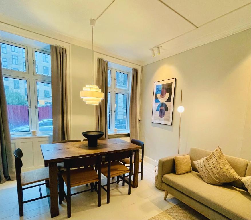 a living room with a table and a couch at Amazing Apartment in Urban Neighborhood in Copenhagen