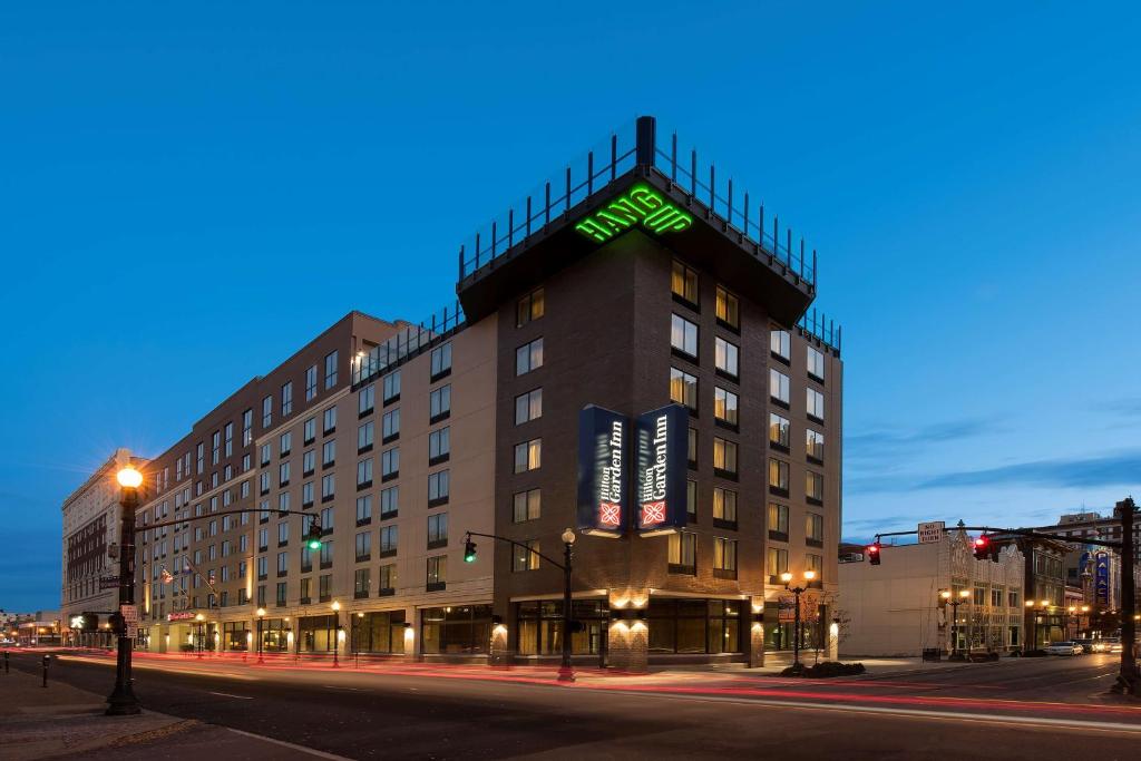 a building with a sign on the top of it at Hilton Garden Inn Louisville Downtown in Louisville