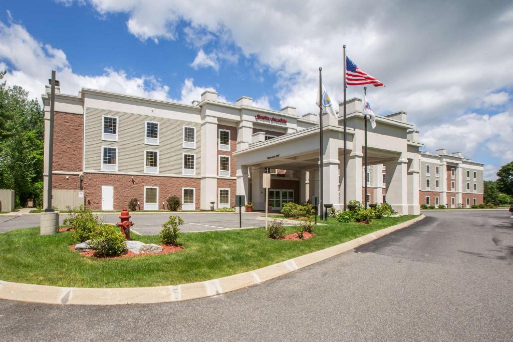 a building with an american flag in front of it at Hampton Inn & Suites Berkshires-Lenox in Lenox