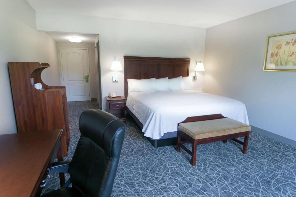 a hotel room with a bed and a desk and a chair at Hampton Inn & Suites Berkshires-Lenox in Lenox