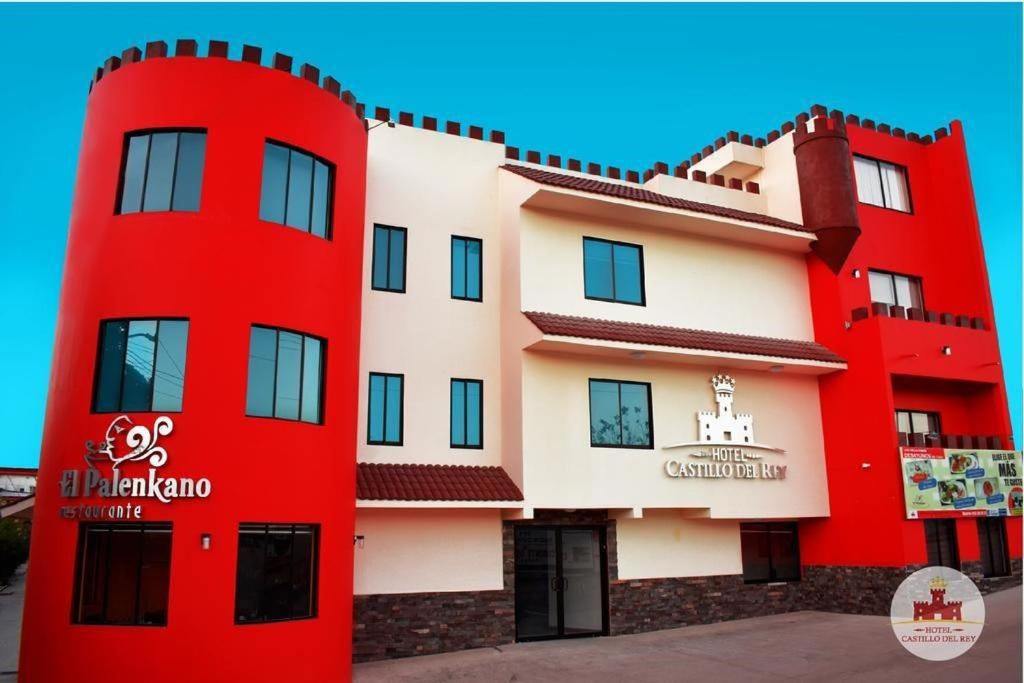 a building with a red and white building at Hotel Castillo Del Rey in Palenque