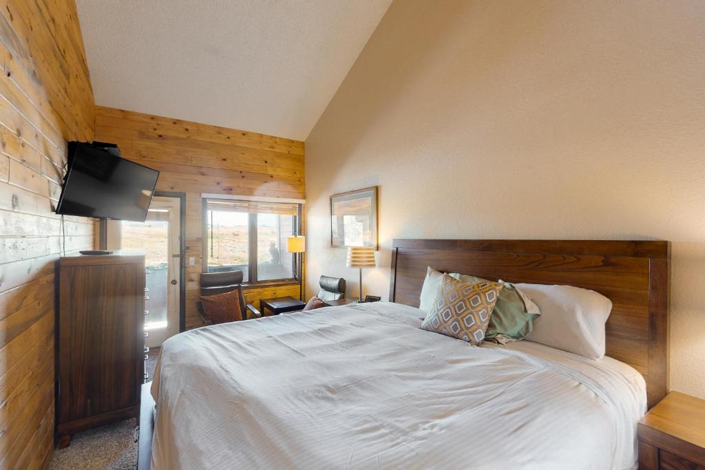 a bedroom with a bed and a television in it at Silver Lodge A in Granby