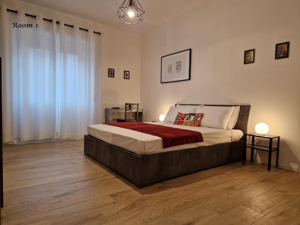a bedroom with a large bed and wooden floors at La casa di Eurialo in Rome