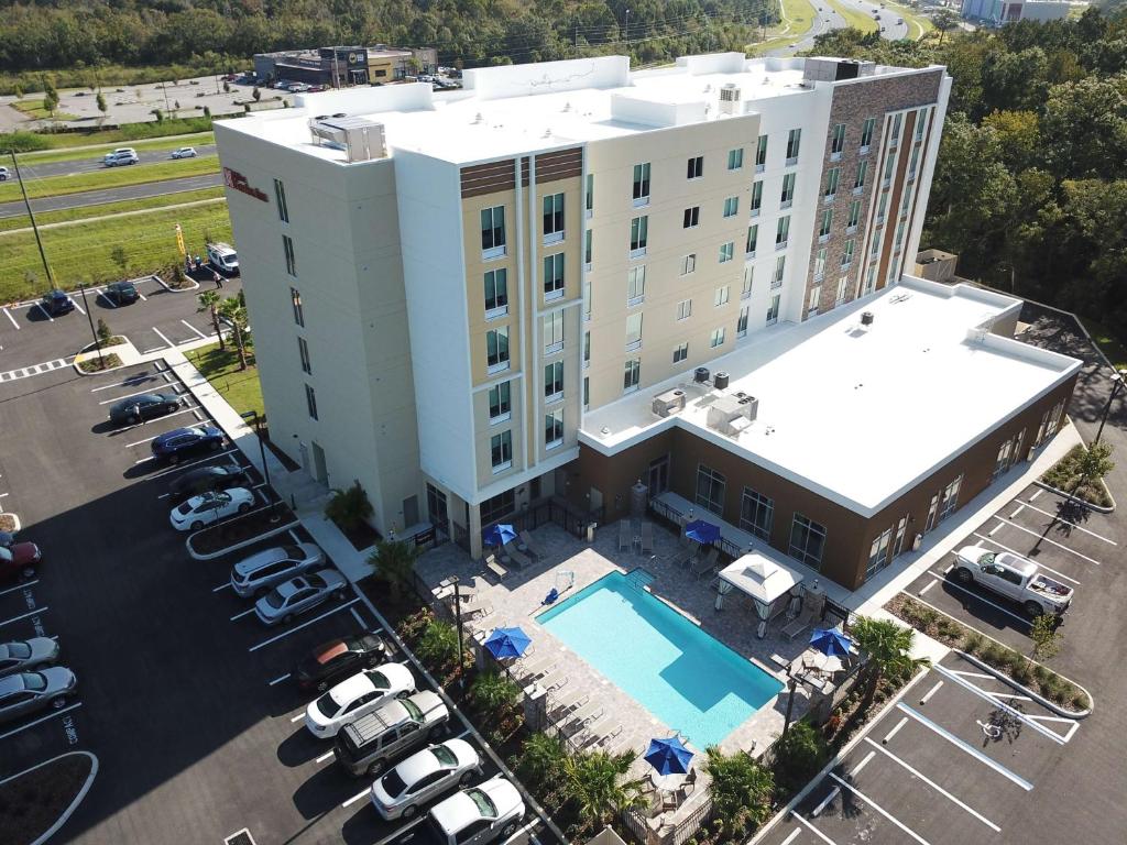 an aerial view of a hotel with a pool and parking lot at Hilton Garden Inn Tampa - Wesley Chapel in Wesley Chapel