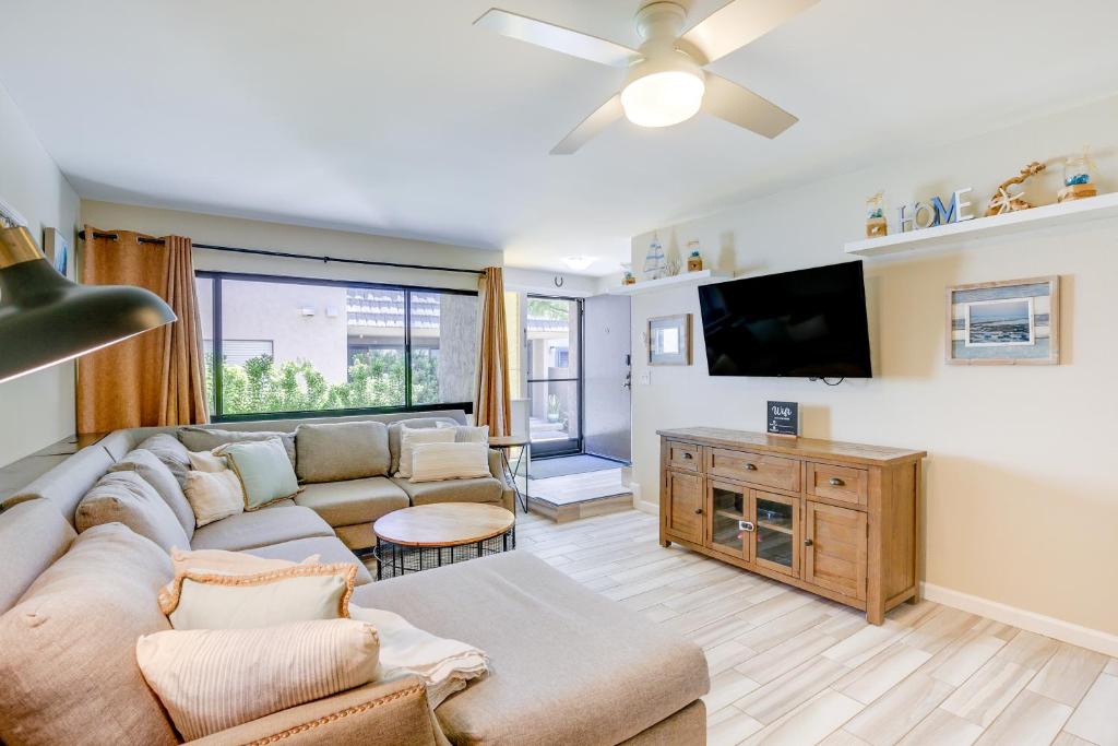 a living room with a couch and a tv at Solana Beach Condo with 4 Pools and Beach Access! in Solana Beach