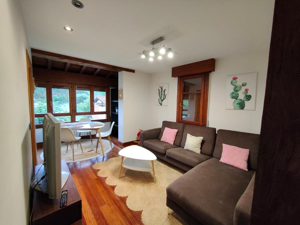 a living room with a couch and a table at Casa in Artea