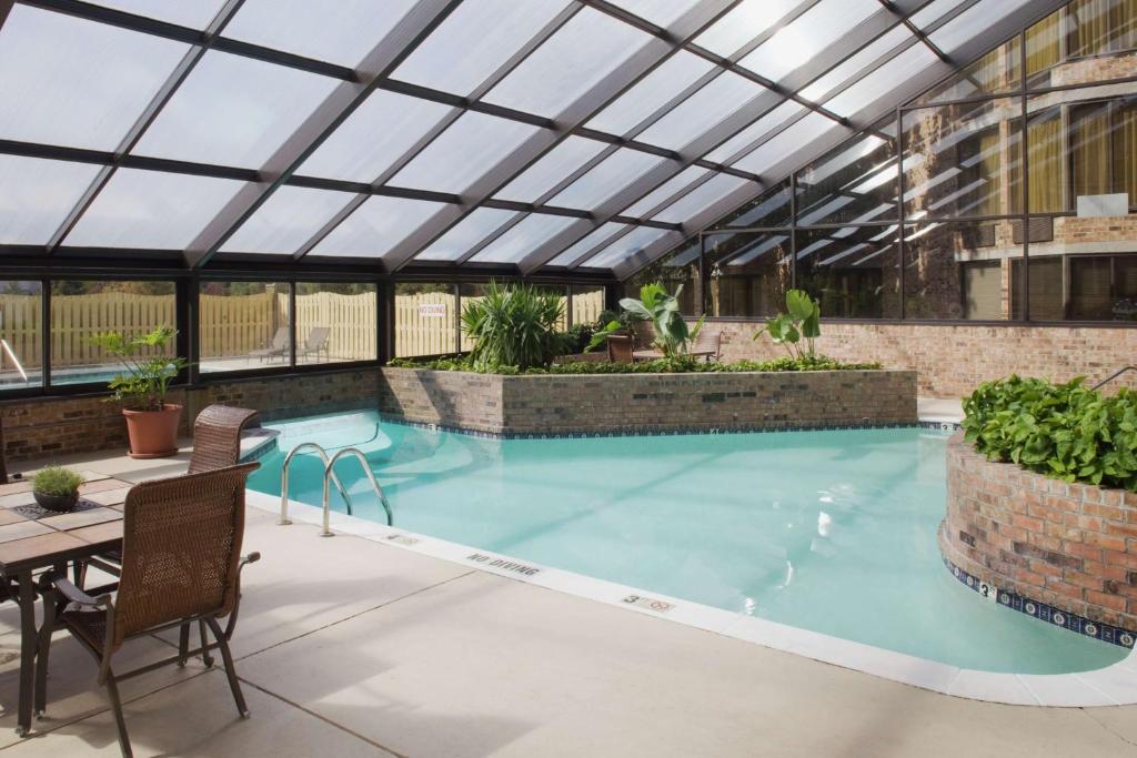 an indoor swimming pool with a glass roof at DoubleTree by Hilton Johnson City in Johnson City