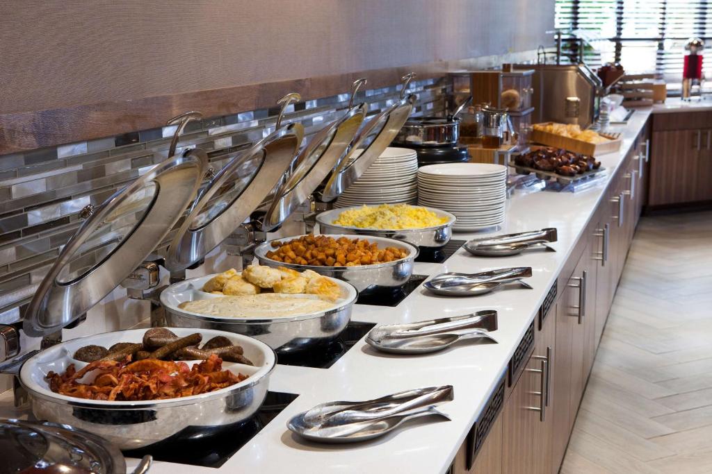 a buffet line with many different dishes of food at DoubleTree by Hilton Johnson City in Johnson City