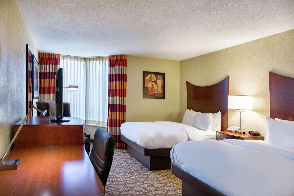 a hotel room with two beds and a desk at DoubleTree by Hilton Johnson City in Johnson City