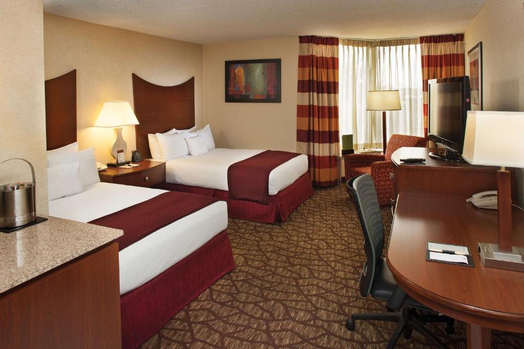 a hotel room with two beds and a desk at DoubleTree by Hilton Johnson City in Johnson City