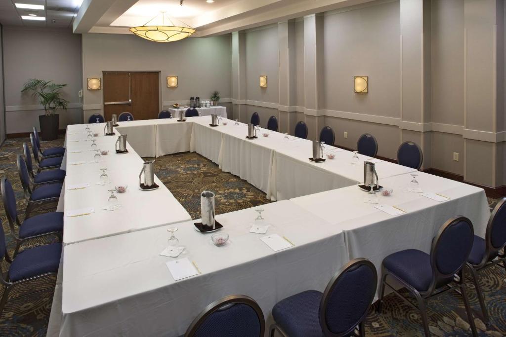 a row of tables in a room with blue chairs at DoubleTree by Hilton Johnson City in Johnson City