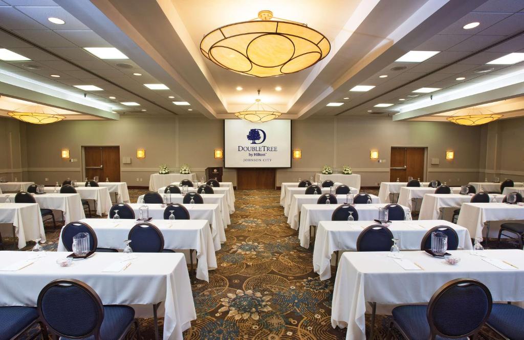 a banquet hall with white tables and chairs at DoubleTree by Hilton Johnson City in Johnson City
