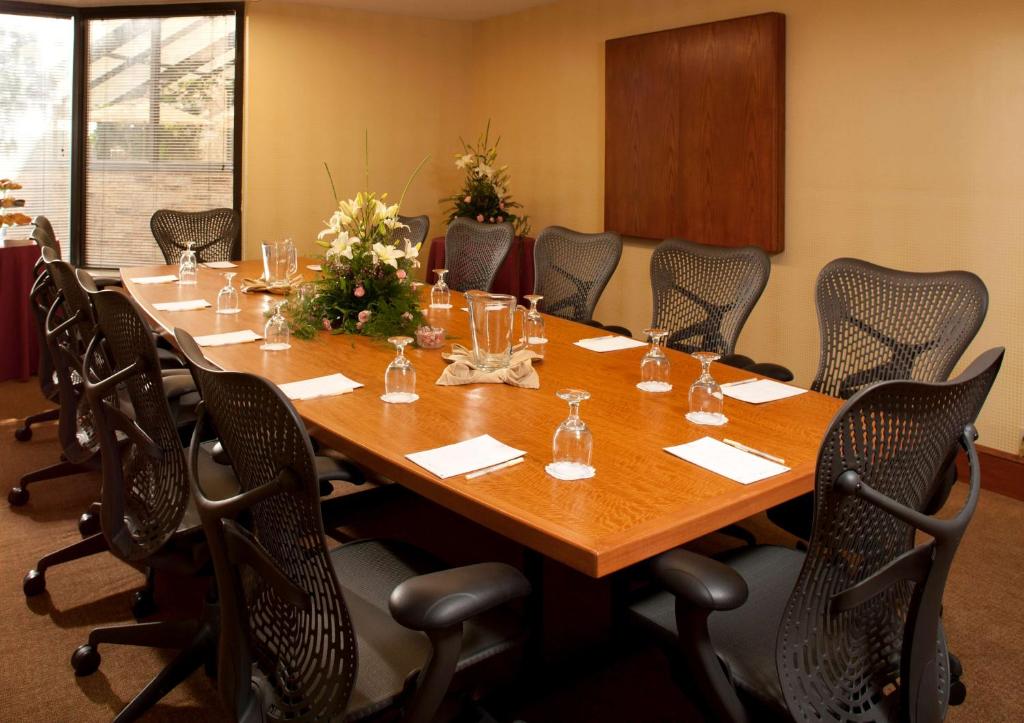 a conference room with a large wooden table and chairs at DoubleTree by Hilton Johnson City in Johnson City