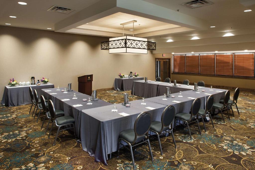 a conference room with long tables and chairs and a chandelier at DoubleTree by Hilton Johnson City in Johnson City
