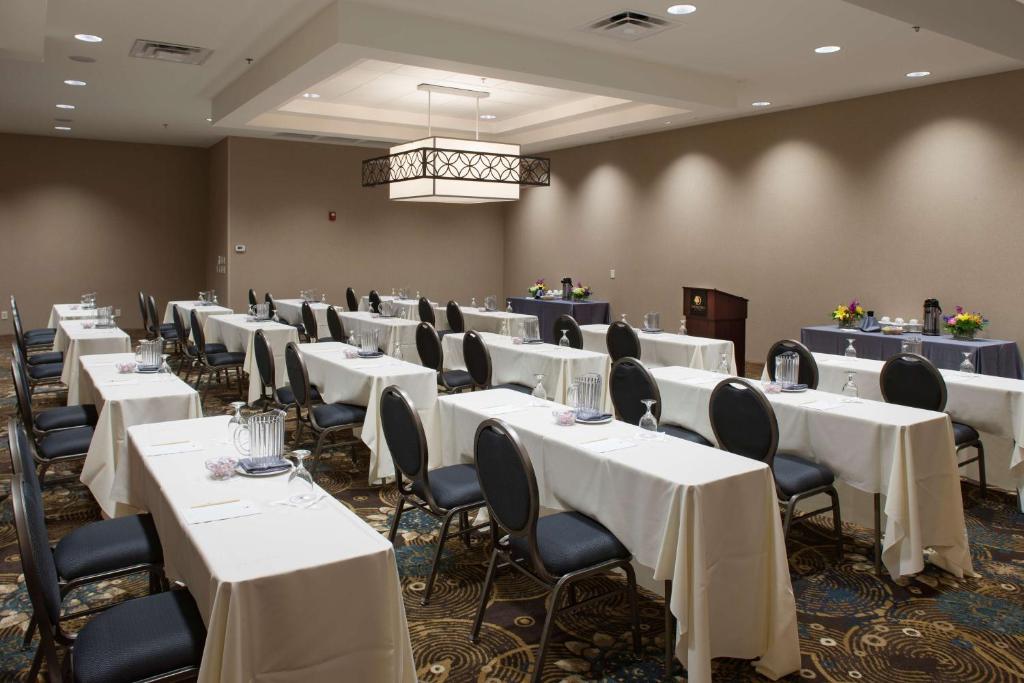 a banquet room with white tables and chairs and a chandelier at DoubleTree by Hilton Johnson City in Johnson City