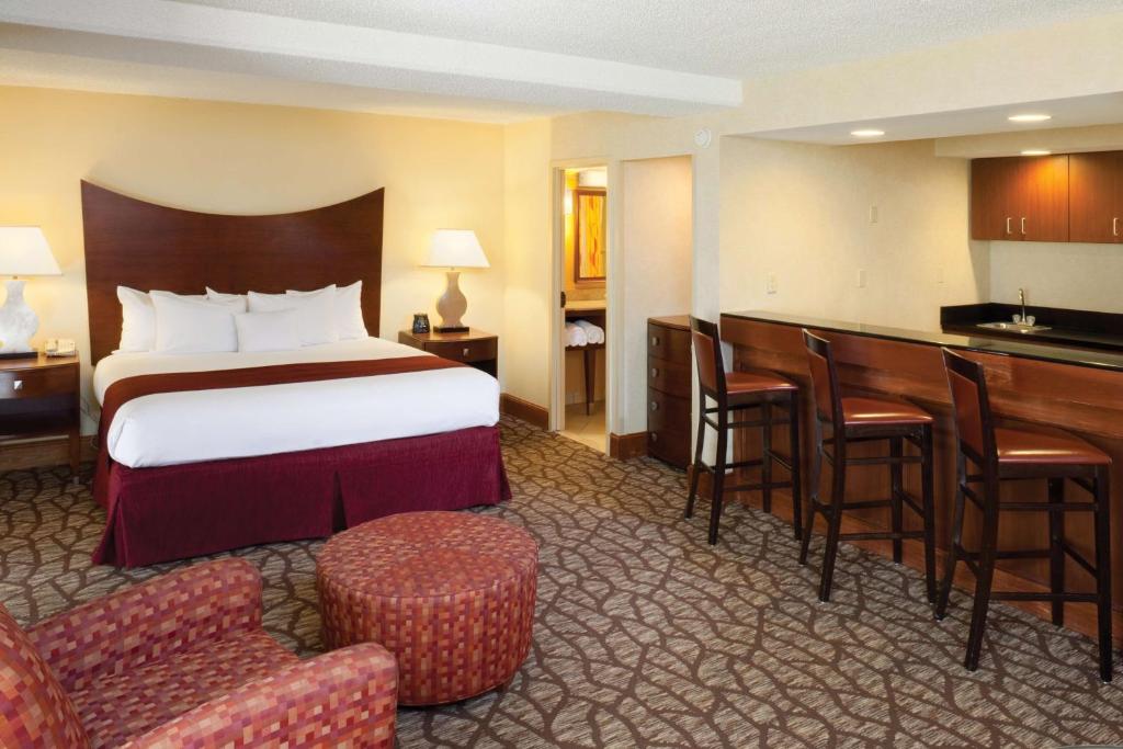 a hotel room with a bed and a bar at DoubleTree by Hilton Johnson City in Johnson City