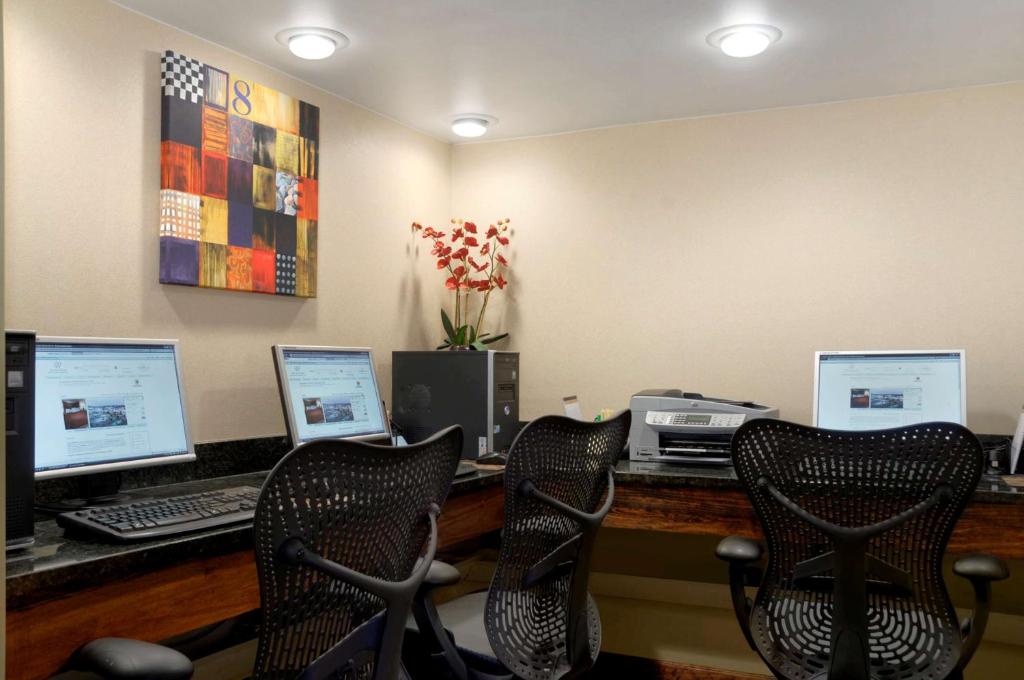 an office with three computer monitors and a printer at DoubleTree by Hilton Johnson City in Johnson City