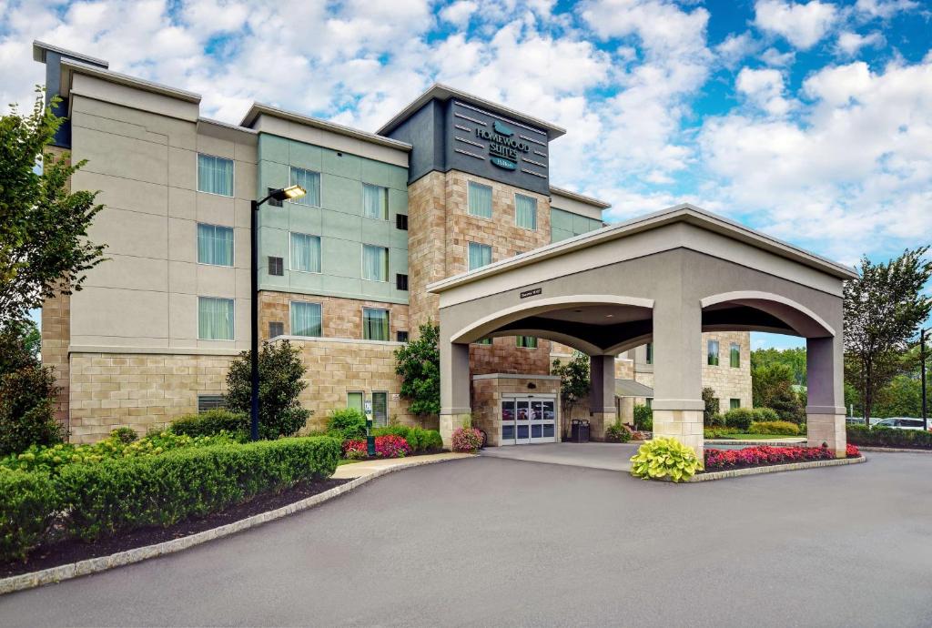 a building with a parking lot in front of it at Homewood Suites by Hilton Hamilton, NJ in Hamilton