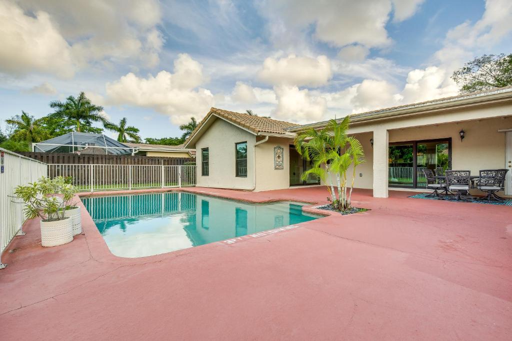 a house with a swimming pool in a yard at Near Golf and Beaches Coral Springs Home with Yard! in Coral Springs