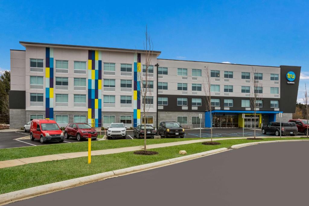 a large building with cars parked in a parking lot at Tru By Hilton Traverse City in Traverse City