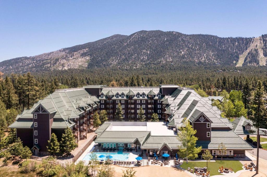 an aerial view of a resort with a pool and mountains at Hilton Vacation Club Lake Tahoe Resort South in South Lake Tahoe