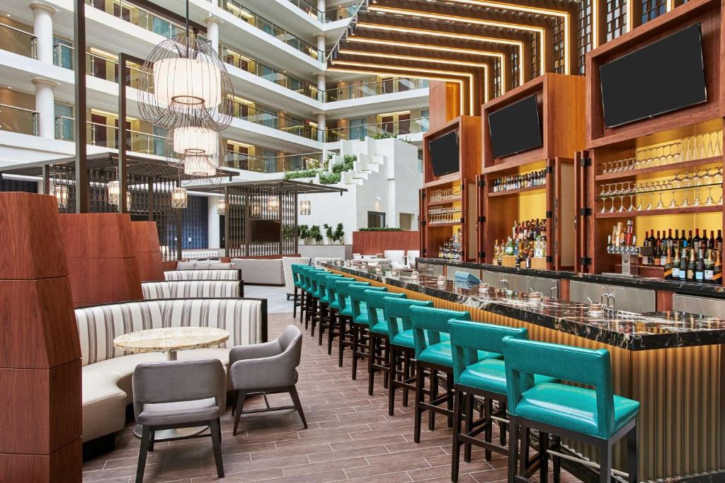 a bar in a hotel with chairs and tables at Embassy Suites by Hilton Washington D.C. Georgetown in Washington, D.C.