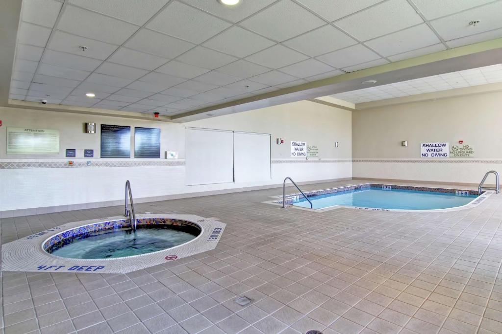 a large room with a hot tub in the middle at Hilton Garden Inn Ottawa Airport in Ottawa