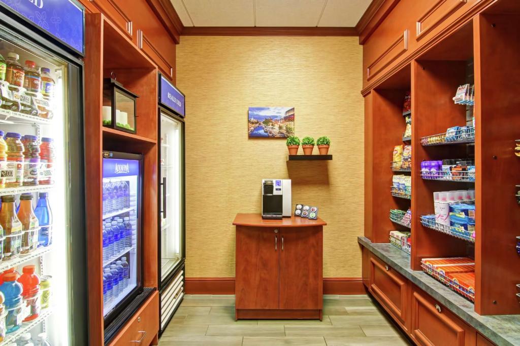 a store aisle of a grocery store with a cash register at Hilton Garden Inn Ottawa Airport in Ottawa
