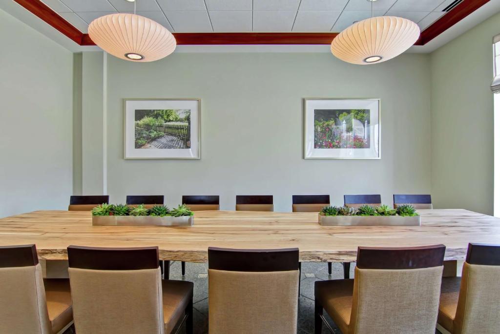 a conference room with a large wooden table and chairs at Hilton Garden Inn Ottawa Airport in Ottawa