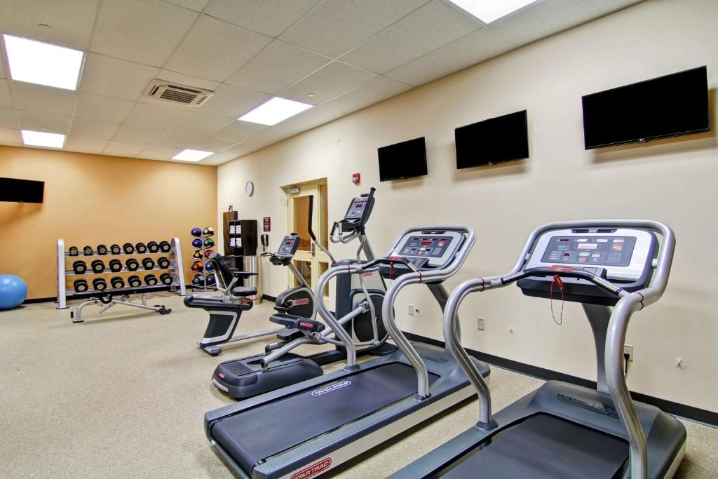 a gym with cardio equipment and tread machines at Hilton Garden Inn Ottawa Airport in Ottawa