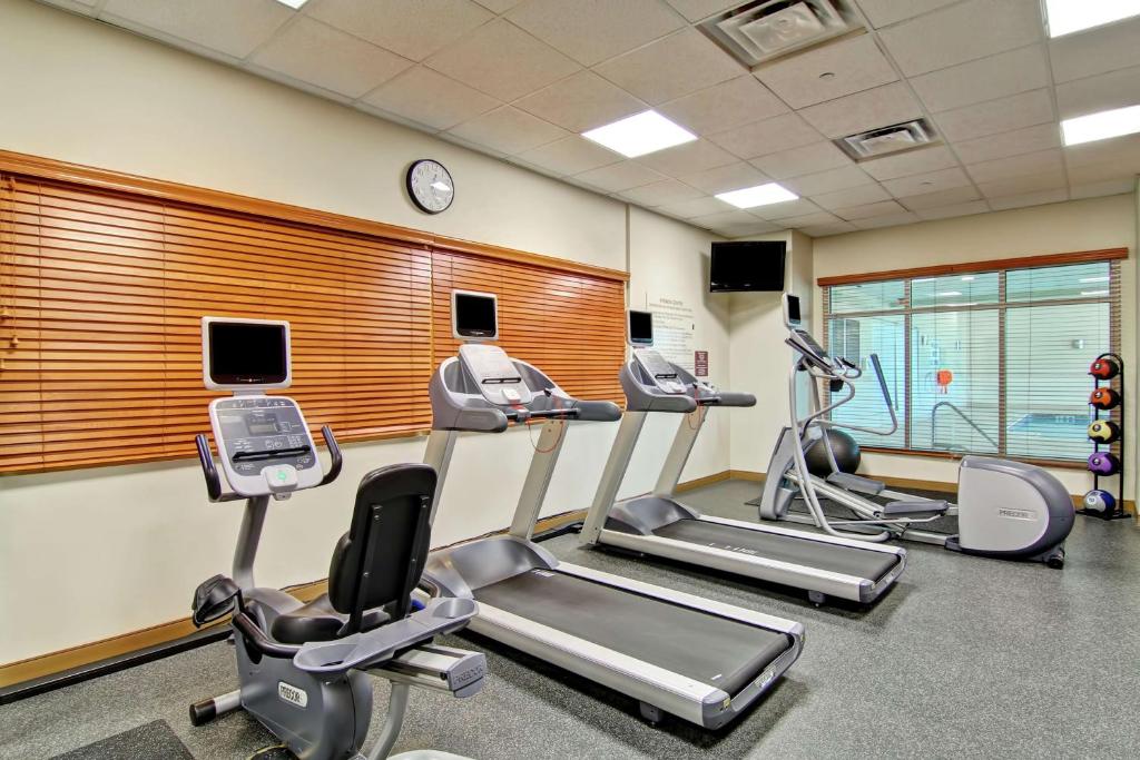 a gym with treadmills and elliptical machines at Hilton Garden Inn Ottawa Airport in Ottawa