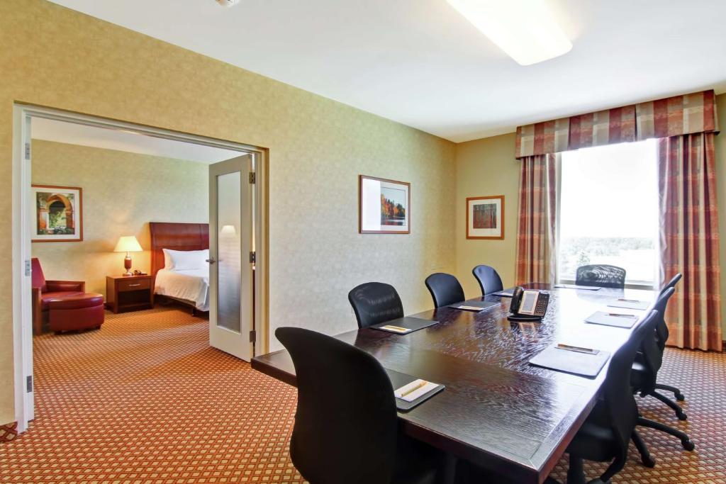 a conference room with a large table and chairs at Hilton Garden Inn Ottawa Airport in Ottawa