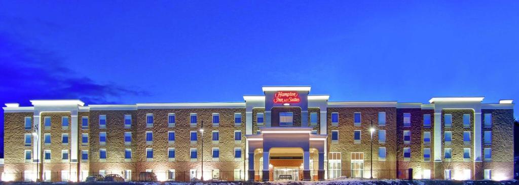 a large building with a sign on the front of it at Hampton Inn & Suites Saint John in Saint John