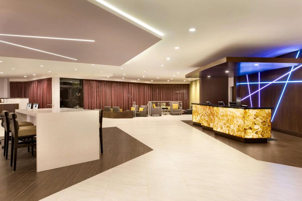 a lobby of a hotel with a bar and chairs at DoubleTree by Hilton Hotel Toronto Airport West in Mississauga