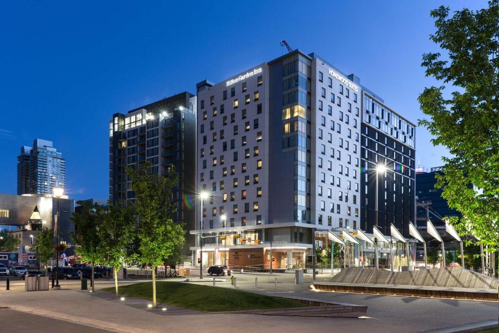 a large building in a city at night at Homewood Suites by Hilton Calgary Downtown in Calgary