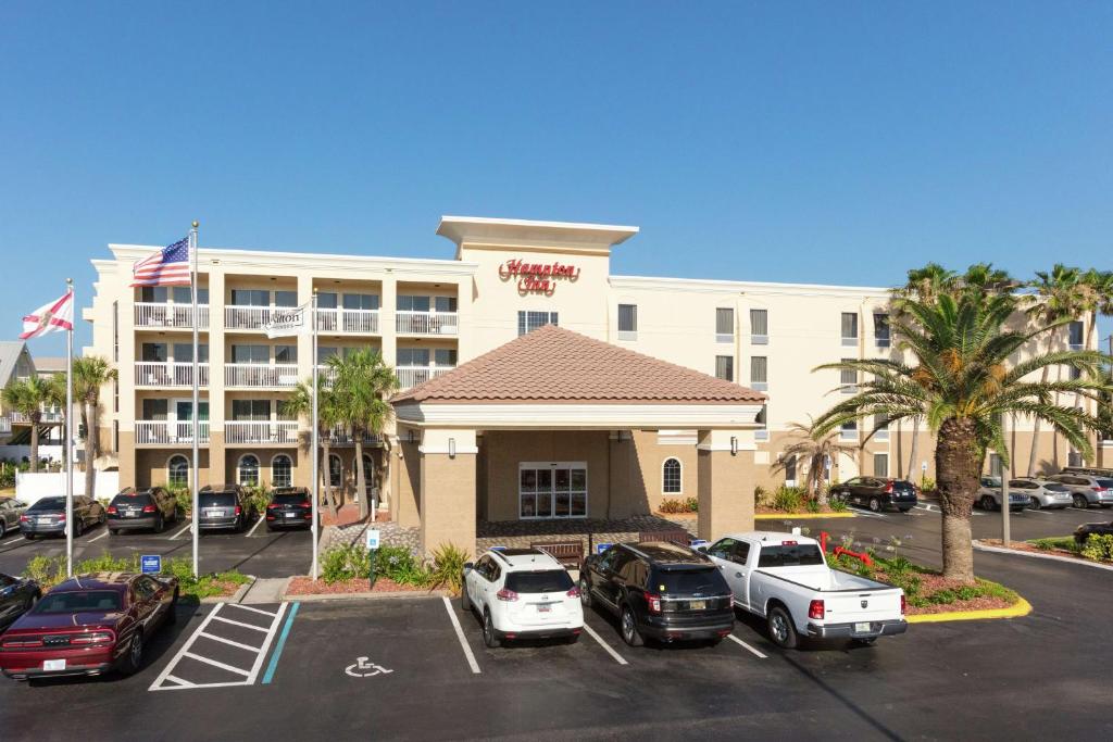 a hotel with cars parked in a parking lot at Hampton Inn Saint Augustine Beach in Saint Augustine Beach