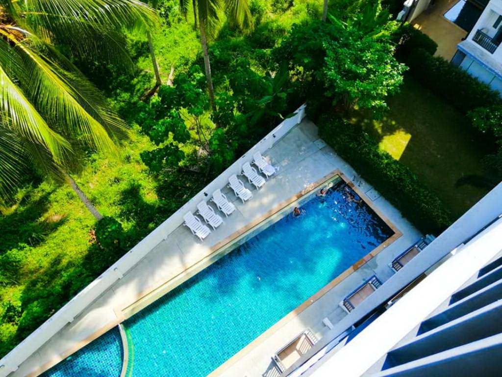 an overhead view of a swimming pool with lawn chairs at Ahad Suite Aonang in Ban Khlong Haeng