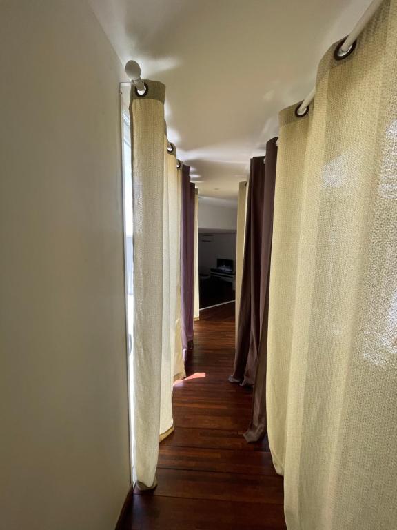 a hallway with curtains in a room with wooden floors at La Casba 15 mm plage Contis in Lévignacq