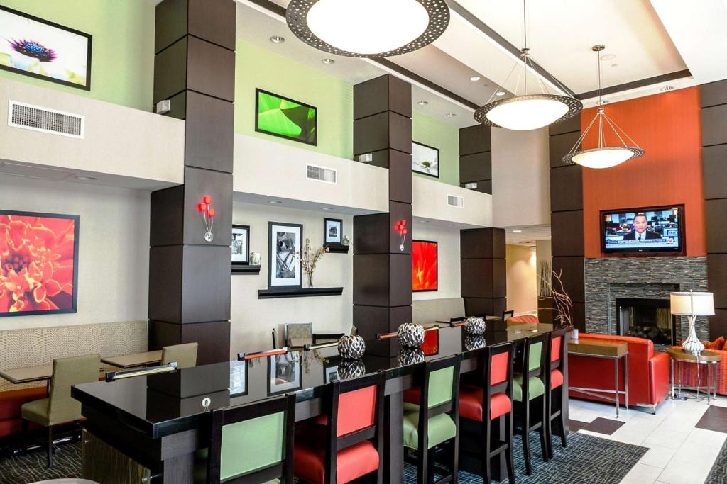a lobby of a hotel with a bar and chairs at Hampton Inn & Suites Tulsa/Tulsa Hills in Tulsa
