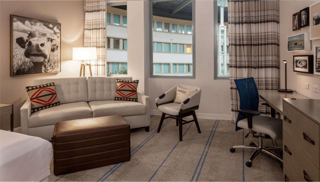 a living room with a couch and a chair at Hilton Austin Airport in Austin