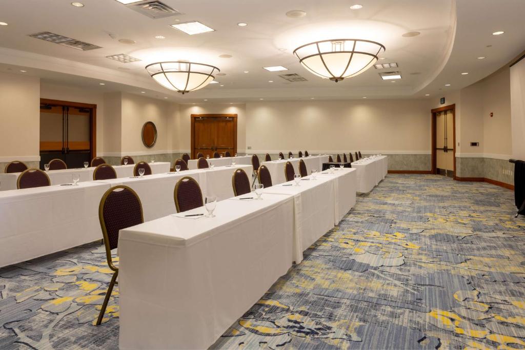 a conference room with white tables and chairs at Hilton Austin Airport in Austin