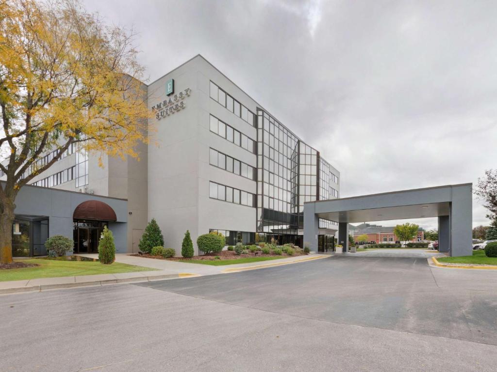 an empty parking lot in front of a building at Embassy Suites by Hilton Milwaukee Brookfield in Brookfield