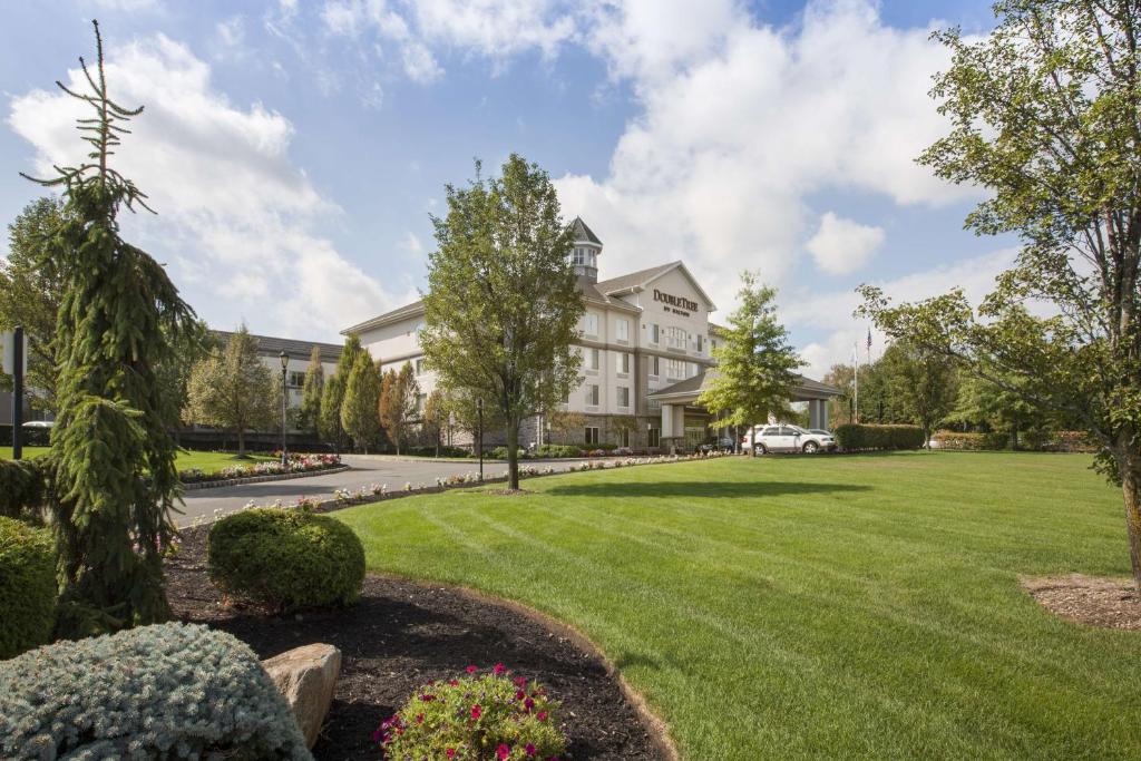 a large house with a lawn in front of it at DoubleTree by Hilton Nanuet in Nanuet