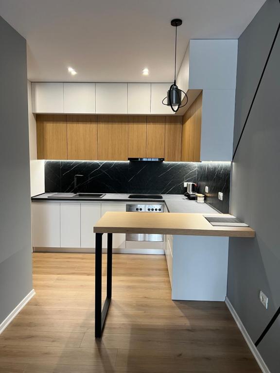 a kitchen with a table in the middle of a room at George apartments2023 in Korçë