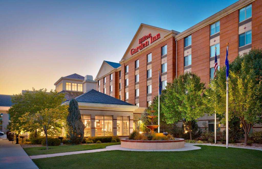 a hotel building with a lawn in front of it at Hilton Garden Inn Salt Lake City/Sandy in Sandy