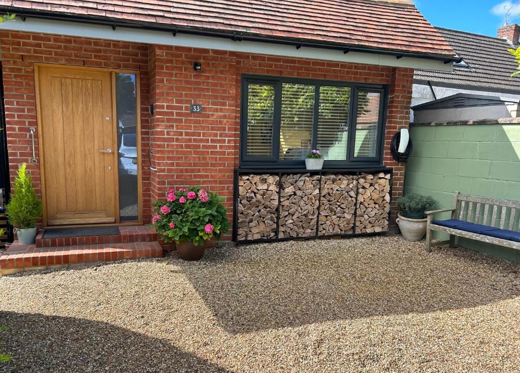 a house with a door and a bench in front of it at Studio 33 in Chichester